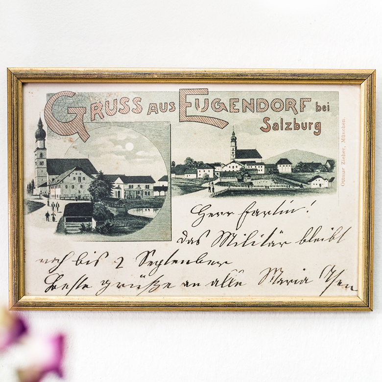 Historische Postkarte „Gruss aus Eugendorf bei Salzburg“ mit Ortsansichten in goldenem Rahmen.